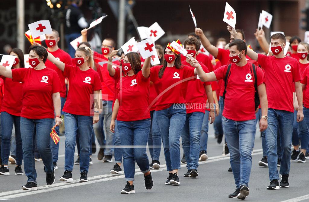 Boris Grdanoski Red Cross volunteers take part in a parade to mark the Independence Day in downtown Skopje, North Macedonia, Wednesday, Sept. 8, 2021. North Macedonia is celebrating Wednesday the 30th anniversary since its independence from former Yugoslavia. (AP Photo/Boris Grdanoski)