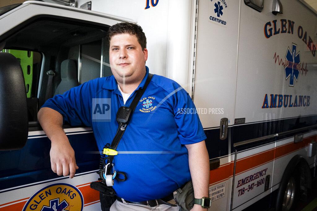 John Minchillo Paramedic Travis Kessel stands for a portrait during the coronavirus outbreak Friday, March 26, 2021, in the Queens borough of New York. “It seems to be we’re heading in the right direction,” Kessel said. “There’s going to be hiccups, but at this point, there is light at the end of the tunnel. Whether it’s real or not is yet to be determined.” (AP Photo/John Minchillo)
