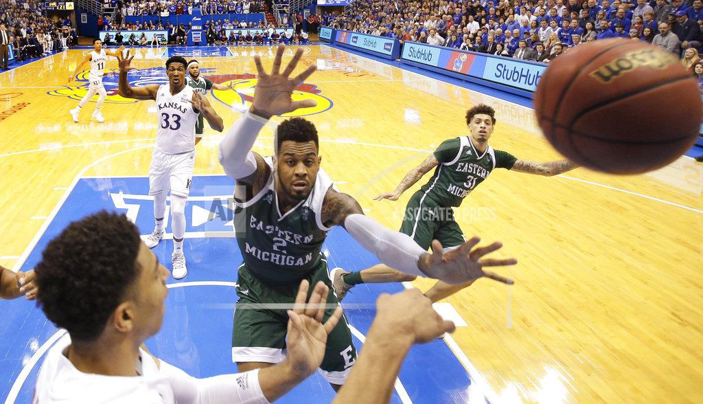 Charlie Riedel Kansas' Devon Dotson, left, passes the ball under pressure from Eastern Michigan's James Thompson IV (2) during the first half of an NCAA college basketball game Saturday, Dec. 29, 2018, in Lawrence, Kan. (AP Photo/Charlie Riedel)