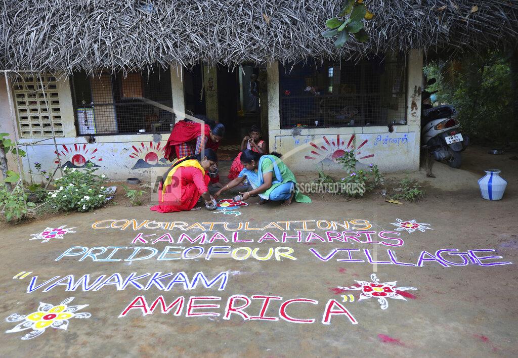 Aijaz Rahi Indian women prepare a Kolam, a traditional art work using colored powder, congratulating U.S. Vice President-elect Kamala Harris in the hometown of Harris' maternal grandfather, in Thulasendrapuram, south of Chennai, Tamil Nadu state, India, Sunday, Nov. 8, 2020. After rooting for Kamala Harris as President-elect Joe Biden running mate, people in her small ancestral Indian village woke up Sunday morning to the news of her making history. (AP Photo/Aijaz Rahi)