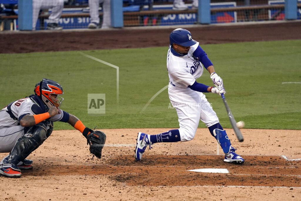 Alex Gallardo Los Angeles Dodgers' Mookie Betts, right, hits a two-run home run with Houston Astros catcher Martin Maldonado, left, watching during the fifth inning of a baseball game in Los Angeles, Sunday, Sept. 13, 2020. (AP Photo/Alex Gallardo)