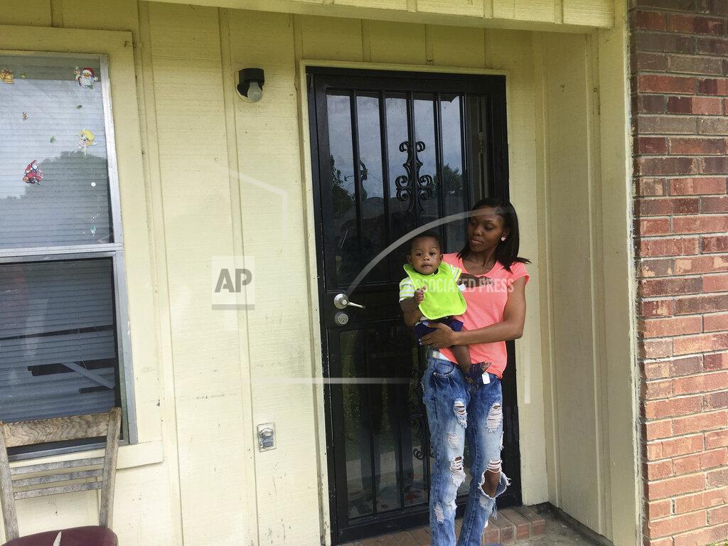 Russell Contreras FILE - In this May 9, 2018, file photo, Starr Jones, 21, stands outside her Shelby, Miss., apartment with her 9-month-old son, Jarvis Kemp, after talking with the nonprofit group Save the Children about her community work to fight poverty. A Save the Children report released Tuesday, June 2, 2020, says childhood disparities around malnutrition, graduation rates, and early deaths are worst in the U.S. among rural, black-majority counties in the American South and isolated counties with Native American populations. (AP Photo/Russell Contreras, File)