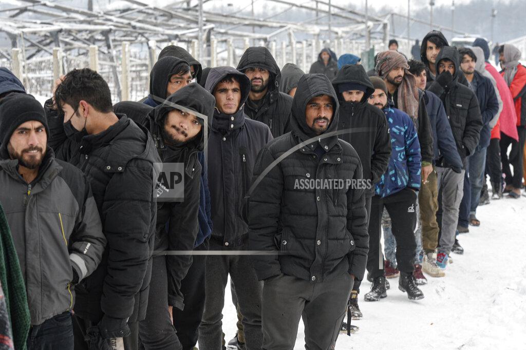 Kemal Softic Migrants wait in a line to receive handouts of food and warm beverages, at the Lipa camp, outside Bihac, Bosnia, Monday, Jan. 11, 2021. Aid workers say migrants staying at a camp in northwestern Bosnia have complained or respiratory and skin diseases after spending days in make-shift tents and containers amid freezing weather and snow blizzards. Most of the hundreds of migrants at the Lipa facility near Bosnia's border with Croatia on Monday have been accommodated in heated military tents following days of uncertainty after a fire gutted most of the camp on Dec. 23. (AP Photo/Kemal Softic)