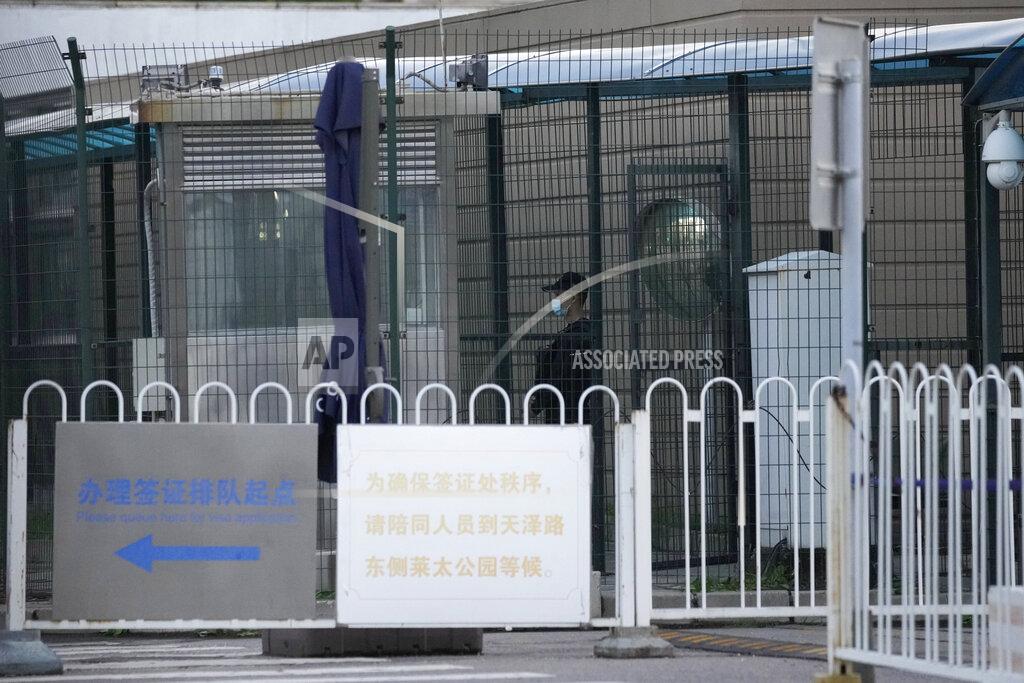 Ng Han Guan A security guard stands guard behind fences around the U.S. embassy near a sign board directing visa applicants in Beijing on Sept. 6, 2021. The Chinese government says at least Chinese 500 students have been rejected under a policy issued last year by then U.S. President Donald Trump that is aimed at blocking Beijing from obtaining U.S. technology with possible military uses. (AP Photo/Ng Han Guan)