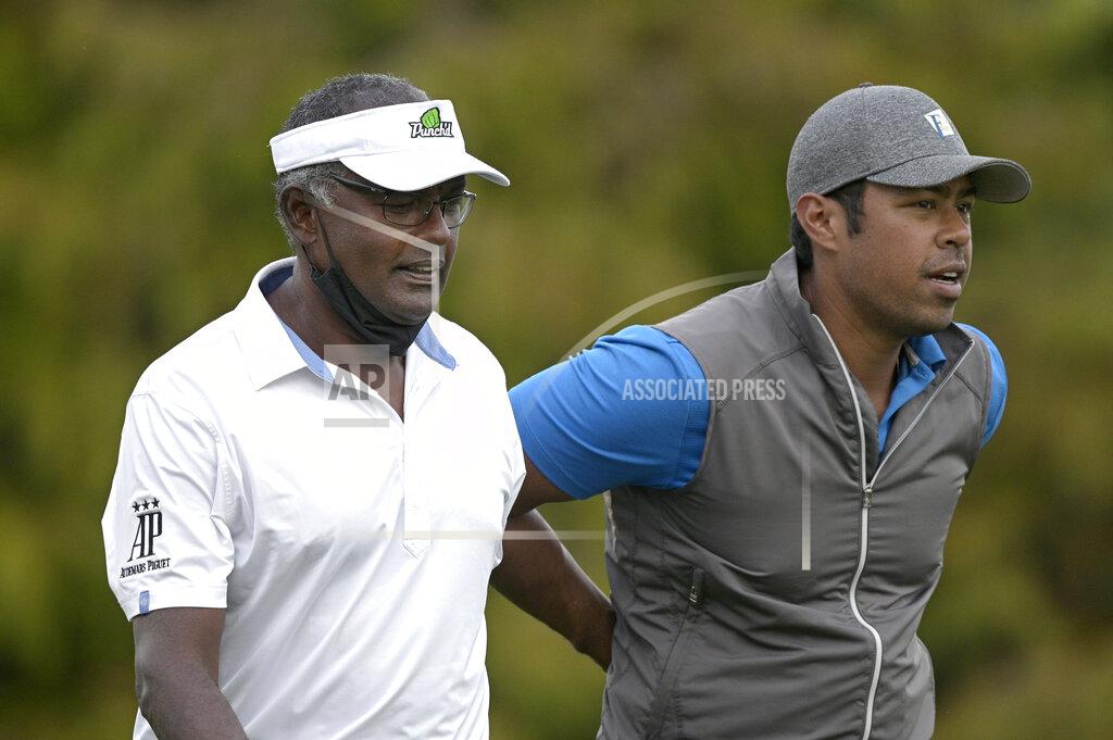 Phelan M. Ebenhack Vijay Singh, left, and his son Qass walk on the 18th fairway after hitting their tee shots during the first round of the PNC Championship golf tournament, Saturday, Dec. 19, 2020, in Orlando, Fla. (AP Photo/Phelan M. Ebenhack)