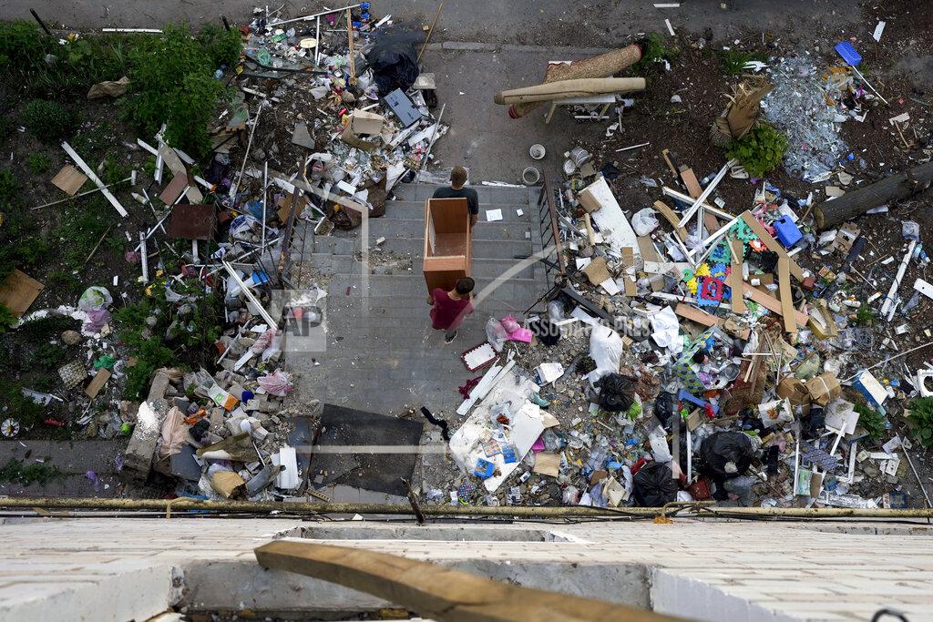 Natacha Pisarenko Residents carry out furniture from houses ruined by shelling in Borodyanka, Ukraine, Tuesday, May 24, 2022. (AP Photo/Natacha Pisarenko)