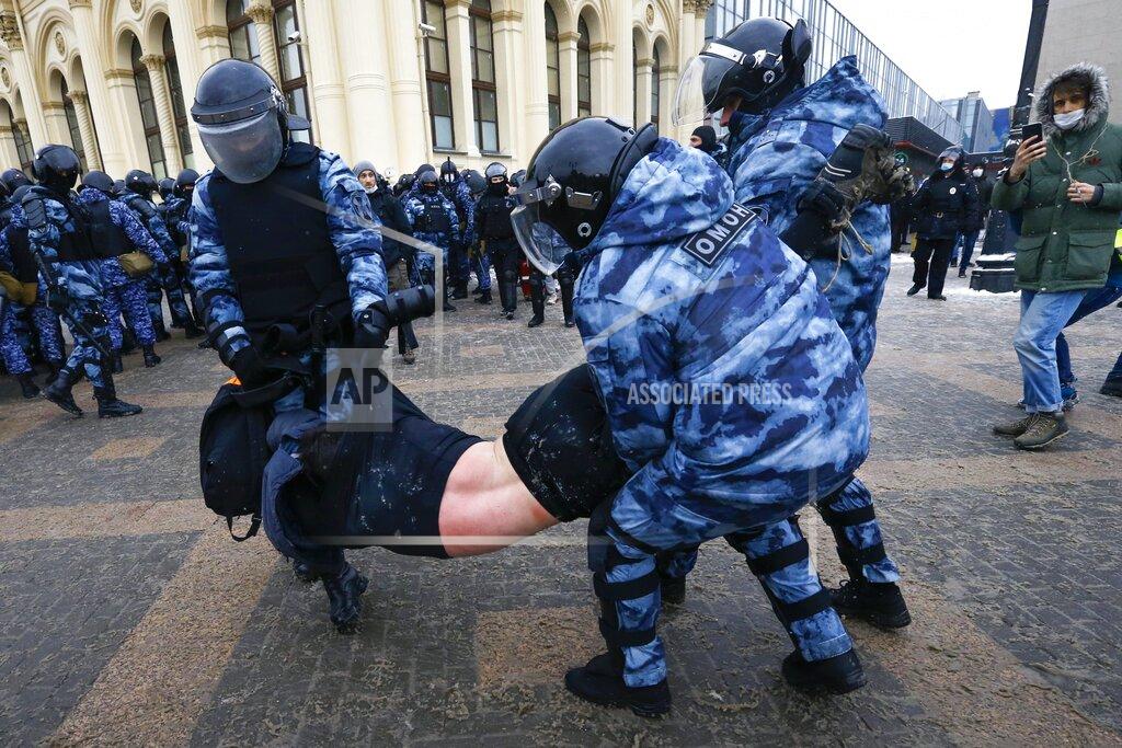 FILE - In this Sunday, Jan. 31, 2021 file photo, police officers detain a man during a protest against the jailing of opposition leader Alexei Navalny in Moscow, Russia. A prison sentence for Russian opposition leader Alexei Navalny and a sweeping crackdown on protesters demanding his release reflect the Kremlin’s steely determination to fend off threats to its political monopoly at any cost. (AP Photo/Alexander Zemlianichenko, File)