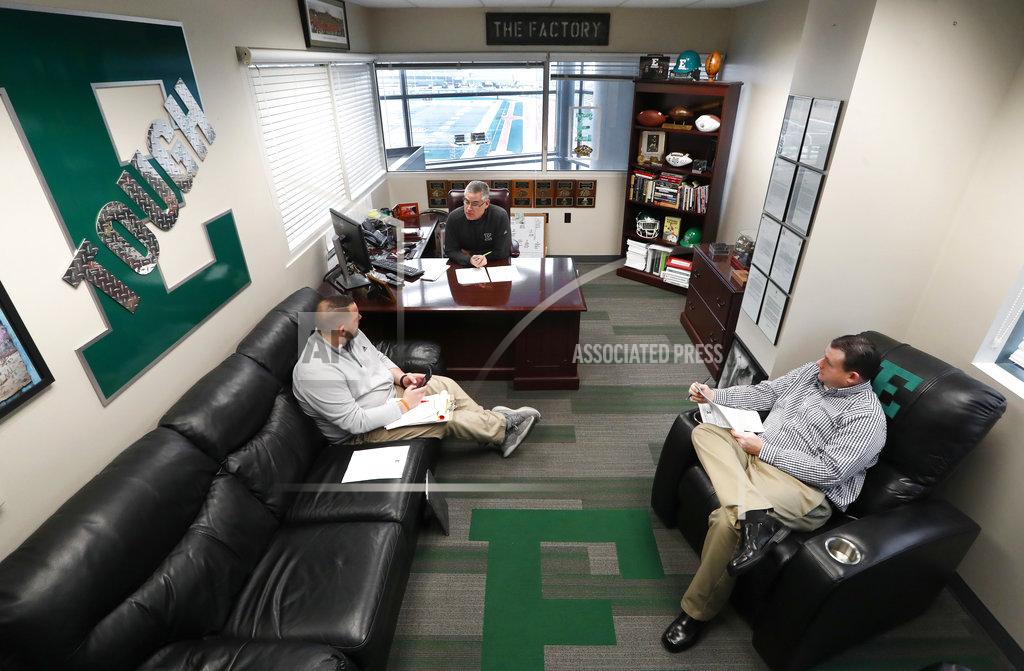 Paul Sancya Eastern Michigan football coach Chris Creighton talks with Dylan Saccade, left, Director of Football Operations and Greg Steiner, right, Associate Athletic Director for Athletic Media Relations about logistics for the teams NCAA football game in the Camellia Bowl in Ypsilanti, Mich., Monday, Dec. 10, 2018. The Eagles will face Georgia Southern in the Camellia Bowl on Saturday, earning a spot in NCAA football postseason play for the second time in three years and just the third time in school history. (AP Photo/Paul Sancya)