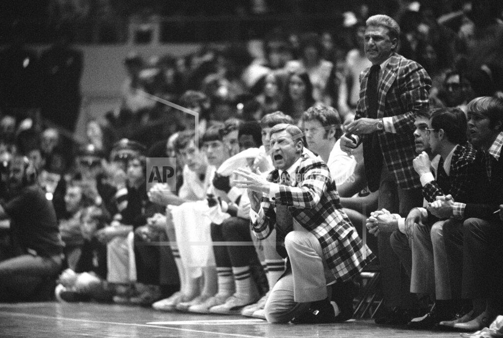 Uncredited FILE - In this March 23, 1974, file photo, North Carolina State basketball coach Norm Sloan gestures from the bench during their double overtime 80-77 victory over UCLA in a semifinal game at the NCAA college basketball championships in Greensboro, N.C. (AP Photo/File)