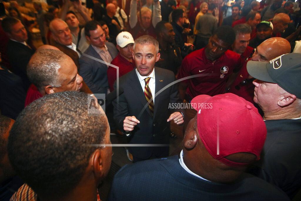 Phil Sears FILE - In this Sunday, Dec. 8, 2019, file photo, new Florida State NCAA college football head coach Mike Norvell talks to football staffers after a news conference, in Tallahassee, Fla. Norvell is taking over a Seminoles program that has struggled while he was helping to build Memphis into a Group of Five power. Florida State got in three practices before the new coronavirus outbreak shut down college sports and upended nearly everything else. (AP Photo/Phil Sears, File)