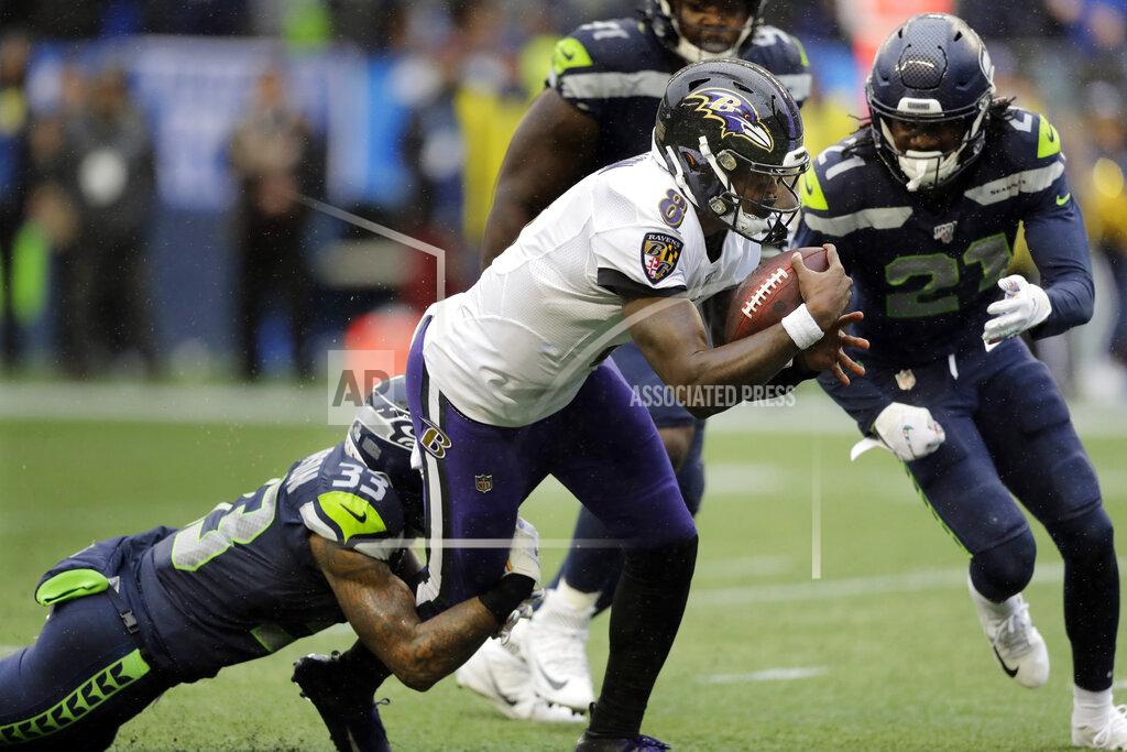 John Froschauer FILE - Baltimore Ravens quarterback Lamar Jackson keeps the ball for a touchdown on a fourth-down play against the Seattle Seahawks during the second half of an NFL football game Oct. 20, 2019, in Seattle. Coaches across the league are more willing than ever to keep the offense on the field instead of kicking on fourth down. The shift began moving in the 2017 season when then-Eagles coach Doug Pederson's aggressive fourth-down strategy helped Philadelphia win the Super Bowl. John Harbaugh and the analytically-sound Ravens took it a step further in the 2019 when the skills of Jackson helped deliver 17 successful fourth-down tries and now teams are going for it more than ever. (AP Photo/John Froschauer, File)