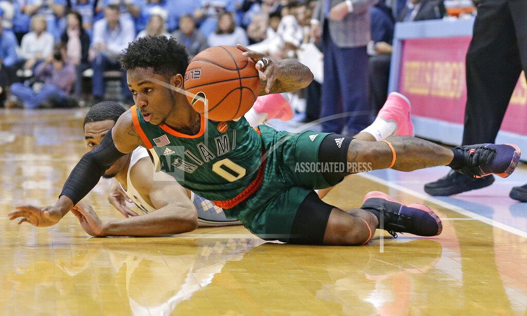 Gerry Broome Miami's Chris Lykes (0) falls to the floor along with North Carolina's Garrison Brooks during overtime in an NCAA college basketball game in Chapel Hill, N.C., Saturday, Feb. 9, 2019. North Carolina won 88-85. (AP Photo/Gerry Broome)