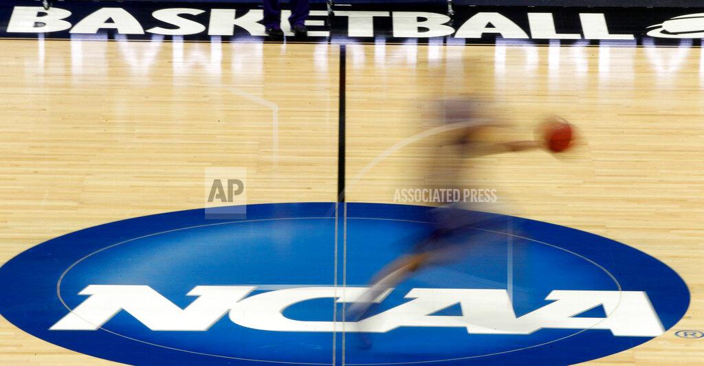 Keith Srakocic FILE - In this March 14, 2012, file photo, a player runs across the NCAA logo during practice in Pittsburgh. The NCAA is moving closer to permitting Division I college athletes to earn money from endorsements and sponsorship deals they can strike on their own. Recommendations for changes to NCAA rules that would permit athletes to earn money for their names, images and likeness are being reviewed by college sports administrators this week before being sent to the association's Board of Governors. (AP Photo/Keith Srakocic, File)