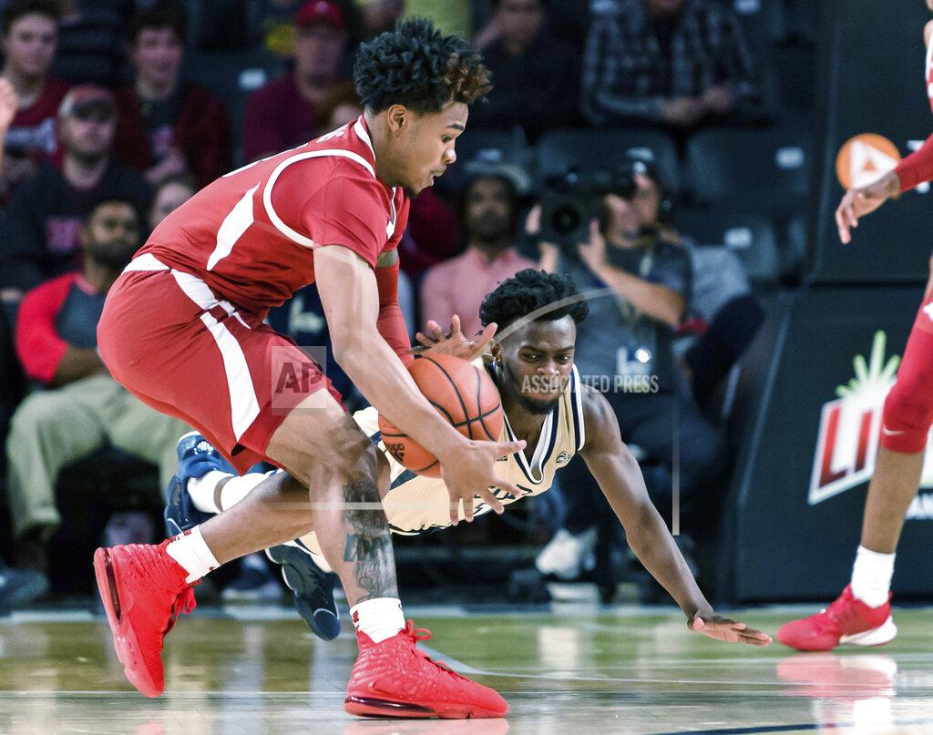 Danny Karnik Georgia Tech guard Bubba Parham (11) dives for a loose ball grabbed by Arkansas guard Desi Sills (3) in the first half of an NCAA college basketball game Monday, Nov. 25, 2019, in Atlanta. (AP Photo/Danny Karnik)