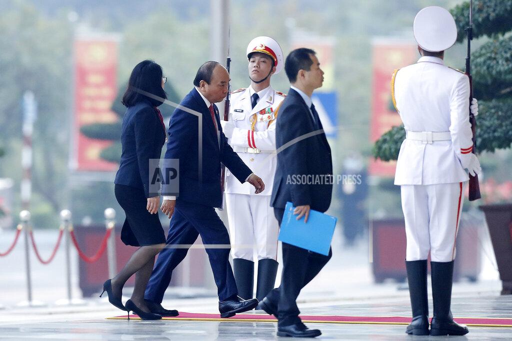 Minh Hoang Vietnam Prime Minister Nguyen Xuan Phuc, second left, arrives at the national convention center to attend the 13th Communist Party Congress in Hanoi, Vietnam Tuesday, Jan. 26, 2021. Vietnam's ruling Communist Party has begun a crucial weeklong meeting in the capital Hanoi to set the nation's path for the next five years and appoint the country's top leaders. (AP Photo/Minh Hoang)