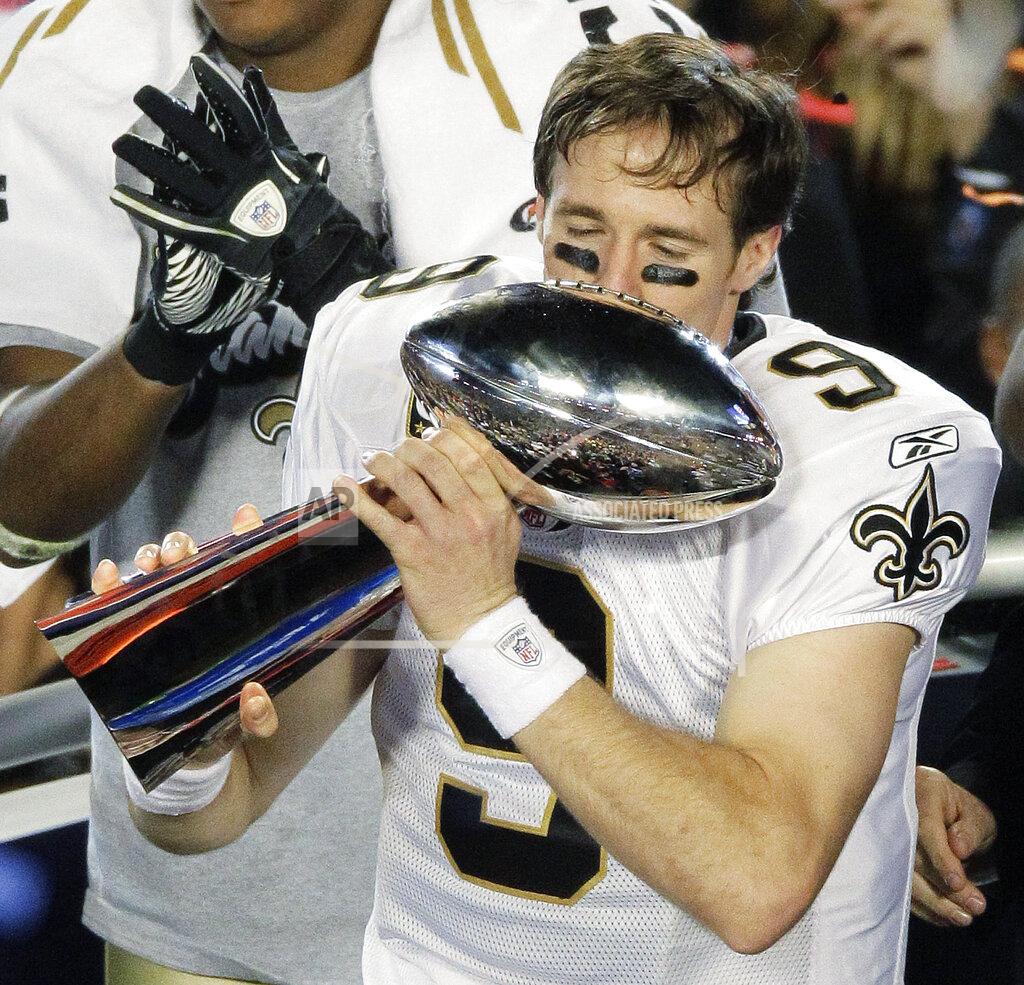 Charlie Riedel File-This Feb. 7, 2010, file photo shows New Orleans Saints quarterback Drew Brees (9) celebrating with the Vince Lombardi Trophy after the NFL Super Bowl XLIV football game against the Indianapolis Colts in Miami. Brees, the NFL’s leader in career completions and yards passing has decided to retire after 20 NFL seasons, including his last 15 with New Orleans. (AP Photo/Charlie Riedel, File)