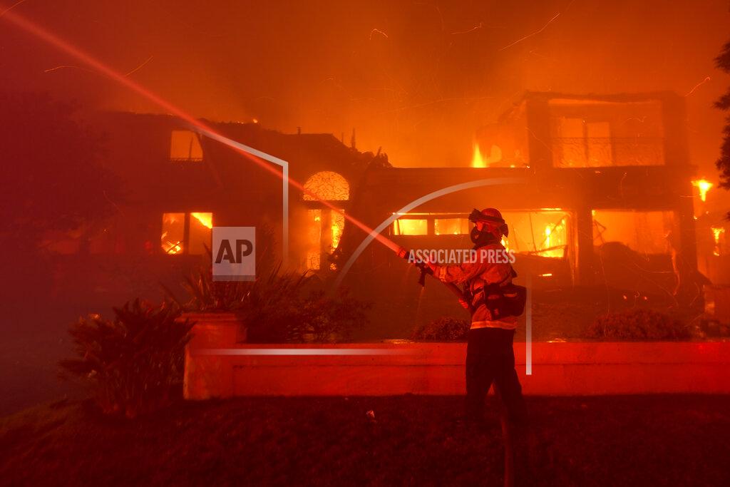 Marcio J. Sanchez A firefighter works to put out a structure burning during a wildfire Wednesday, May 11, 2022, in Laguna Niguel, Calif. (AP Photo/Marcio J. Sanchez)
