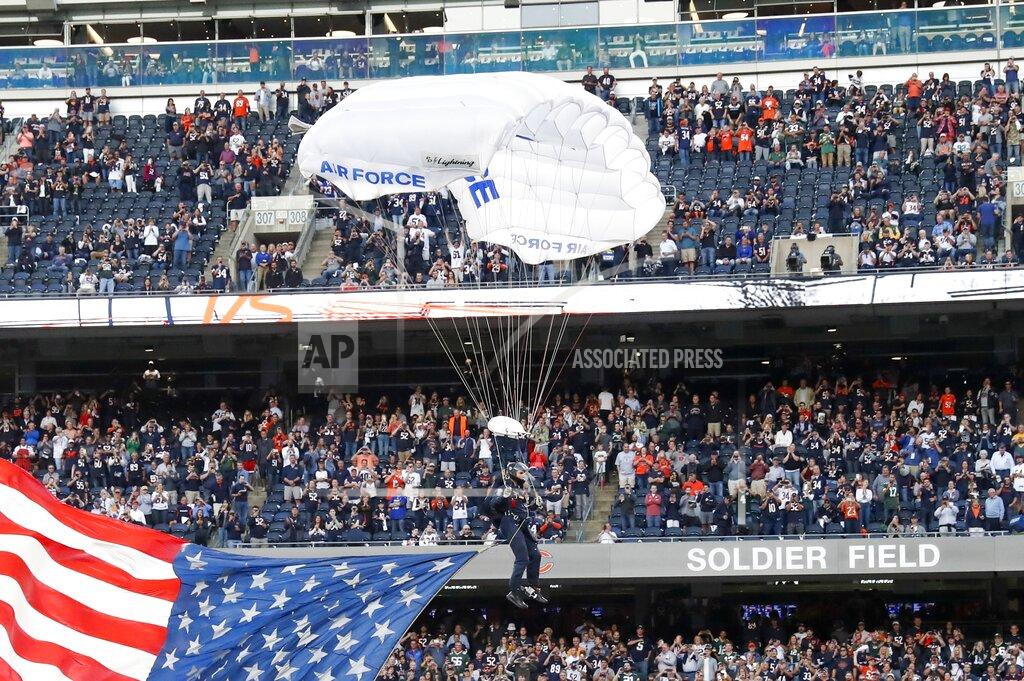 Charles Rex Arbogast A member of the U.S. Air Force parachutes into Soldier Field before an NFL football game between the Green Bay Packers and the Chicago Bears Thursday, Sept. 5, 2019, in Chicago. (AP Photo/Charles Rex Arbogast)