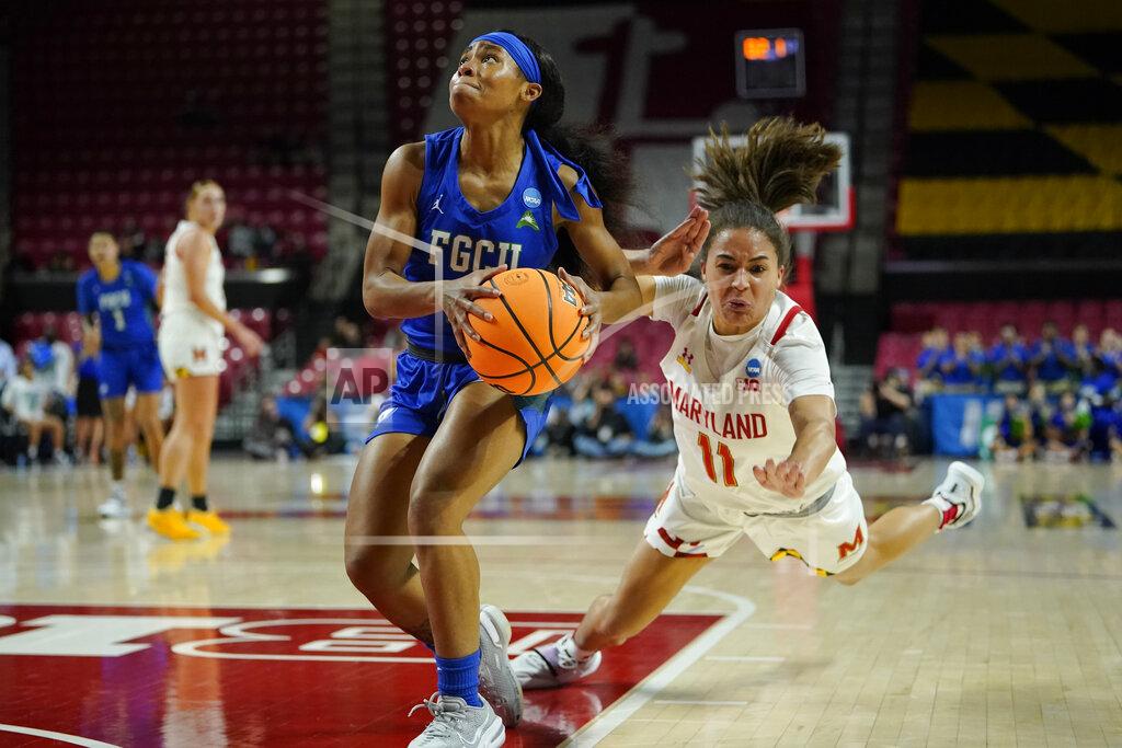 Julio Cortez Florida Gulf Coast guard Tishara Morehouse, left, drives to the basket as Maryland guard Katie Benzan loses her footing during the first half of a college basketball game in the second round of the NCAA tournament, Sunday, March 20, 2022, in College Park, Md. (AP Photo/Julio Cortez)