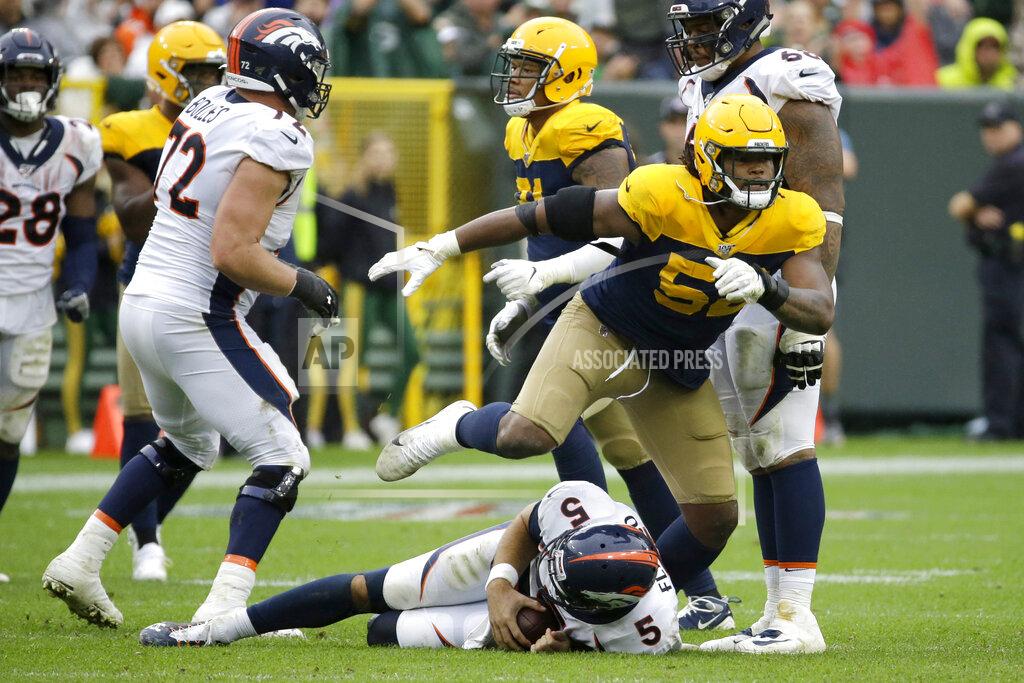 Mike Roemer Green Bay Packers linebacker Rashan Gary, top, celebrates after sacking Denver Broncos quarterback Joe Flacco, bottom, during the second half of an NFL football game Sunday, Sept. 22, 2019, in Green Bay, Wis. Green Bay won 27-16. (AP Photo/Mike Roemer)