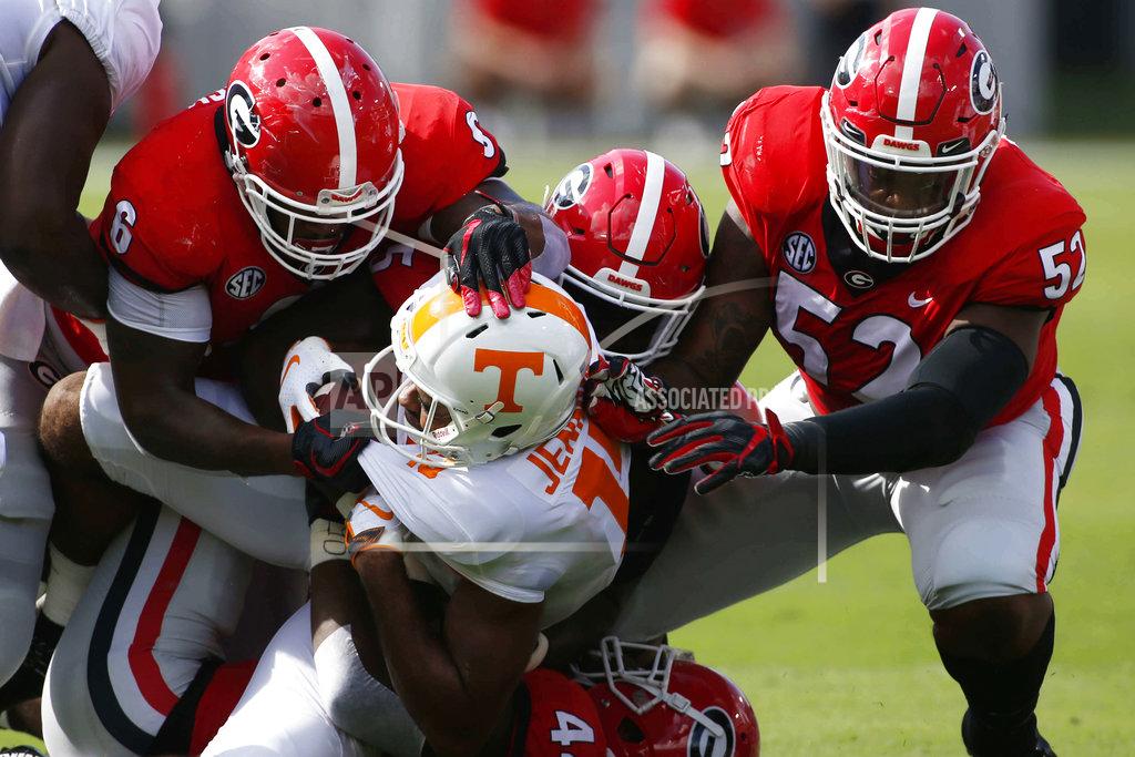 Joshua L. Jones Georgia inside linebacker Natrez Patrick (6) linebacker Juwan Taylor (44) and defensive lineman Tyler Clark (52) take down Tennessee wide receiver Jauan Jennings (15) during the first half of an NCAA college football game, Saturday, Sept. 29, 2018, at Sanford Stadium in Athens, Ga. (Joshua L. Jones/Athens Banner-Herald via AP)