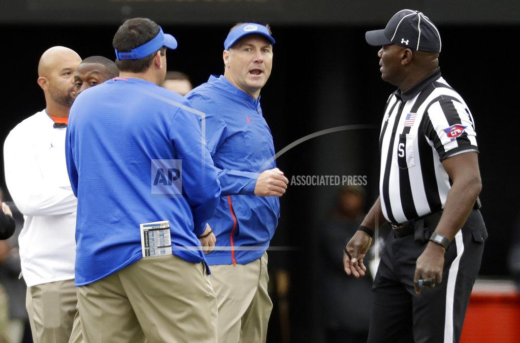 Mark Humphrey Florida head coach Dan Mullen, center, talks to side judge Michael Williams, right, after Florida and Vanderbilt coaches and players had a confrontation in the first half of an NCAA college football game Saturday, Oct. 13, 2018, in Nashville, Tenn. (AP Photo/Mark Humphrey)