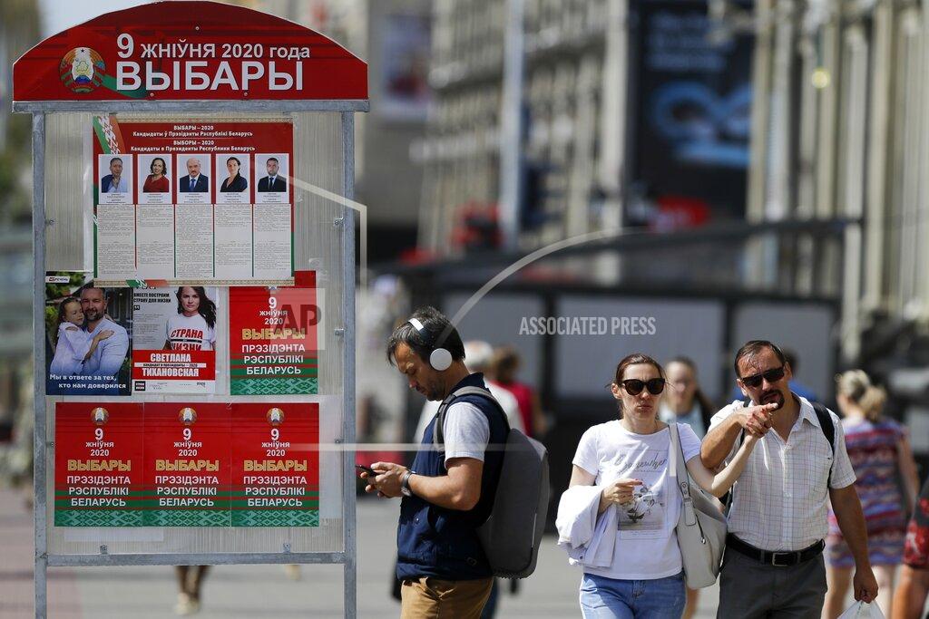Sergei Grits People walk past a billboard on the street with portraits of presidential candidates ahead of Sunday's election in Minsk, Belarus, Tuesday, Aug. 4, 2020. Belarus's authoritarian leader is vowing to maintain a close alliance with Russia despite the latest tensions as he seeks a sixth term in office amid a surge of opposition protests. President Alexander Lukashenko's comments in a state-of-the-nation address ahead of Sunday's election contrast with his diatribes against Russia last week. (AP Photo/Sergei Grits)