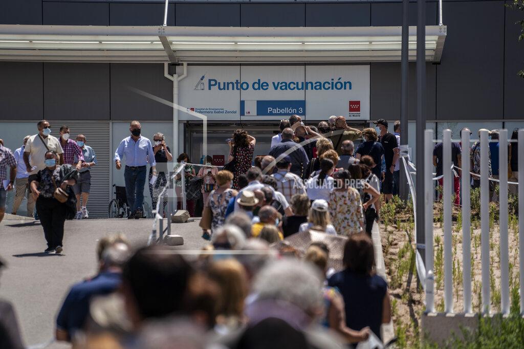 Olmo Calvo Hundreds of people queue to be vaccinated against COVID-19 at the Enfermera Isabel Zendal Hospital in Madrid, Spain, Tuesday, July 7, 2021. Spain is trying to stamp out a new wave of COVID-19 among its youth thanks to a robust vaccination program that is widely supported. Spain like the rest of the European Union got off to a slow start to compared to the United States and Britain when the first vaccines were released. (AP Photo/Olmo Calvo)