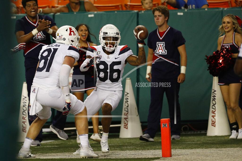 Marco Garcia After scoring a second half touchdown against Hawaii, Arizona wide receiver Stanley Berryhill III (86) and Arizona tight end Bryce Wolma (81)during an NCAA college football game, Saturday, Aug. 24, 2019, in Honolulu. (AP Photo/Marco Garcia)