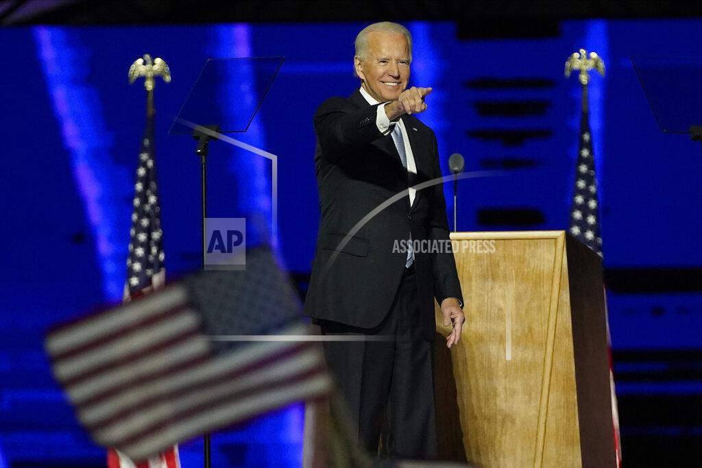 President-elect Joe Biden gestures on stage after speaking, Saturday, Nov. 7, 2020, in Wilmington, Del. (AP Photo/Andrew Harnik, Pool)
