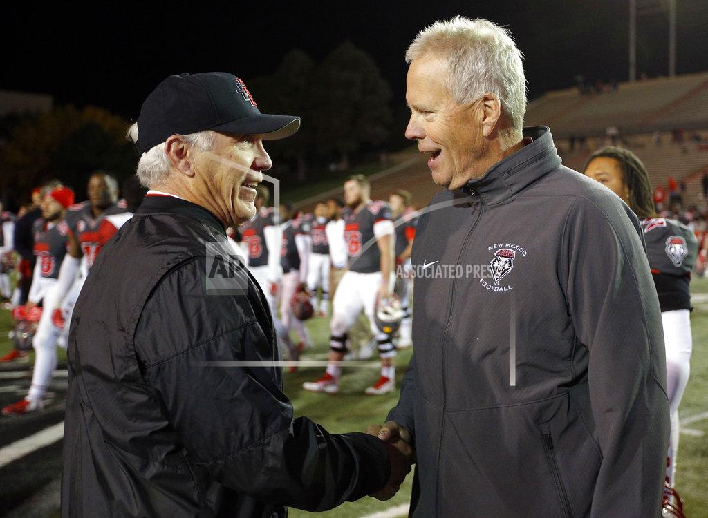 Andres Leighton San Diego State coach Rocky Long, left, is congratulated by New Mexico coach Bob Davie after San Diego State beat New Mexico 31-23 in an NCAA college football game in Albuquerque, N.M., Saturday, Nov. 3, 2018. (AP Photo/Andres Leighton)