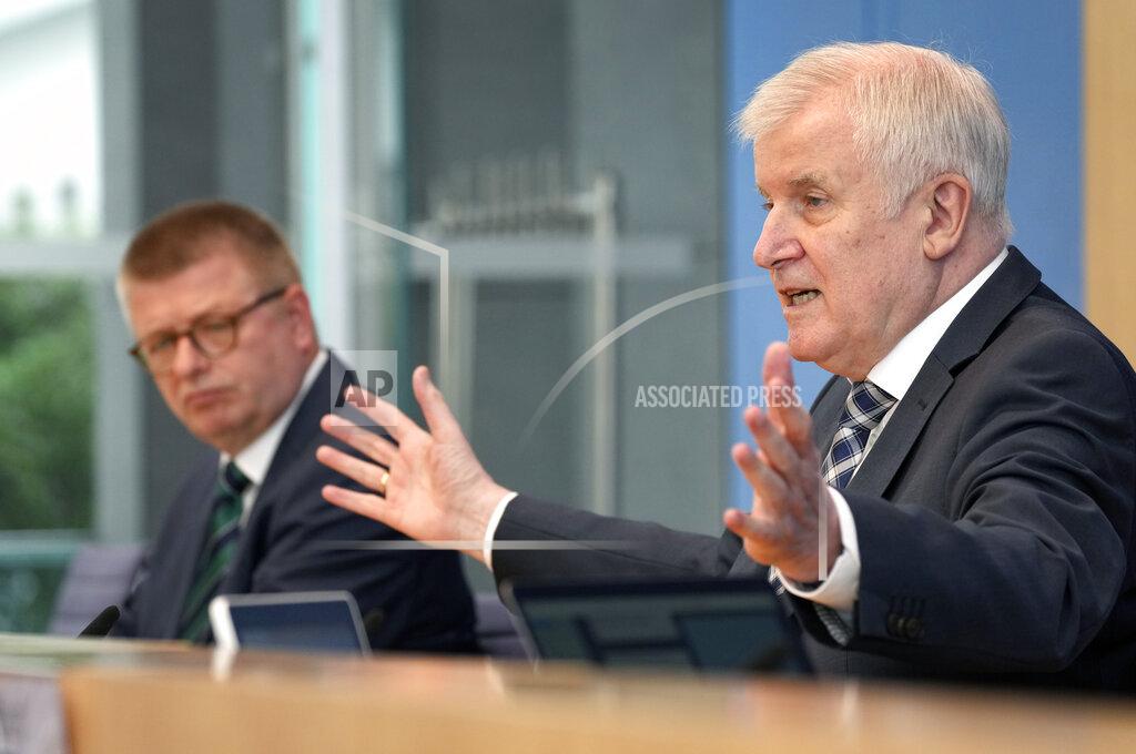 Michael Sohn German Interior Minister Horst Seehofer, right, and Thomas Haldenwang, left, head of the German Federal Office for the Protection of the Constitution, address the media during a press conference on the 'Constitution Protection Report 2020' in Berlin, Germany, Tuesday, June 15, 2021. (AP Photo/Michael Sohn, pool)