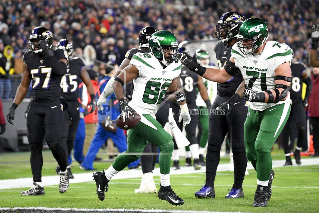 Nick Wass New York Jets wide receiver Jamison Crowder (82) celebrates his touchdown catch with offensive guard Alex Lewis (71) during the first half of an NFL football game against the Baltimore Ravens, Thursday, Dec. 12, 2019, in Baltimore. (AP Photo/Nick Wass)