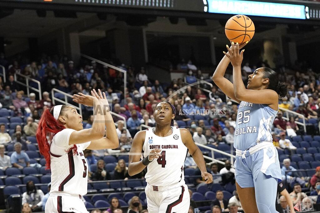 Gerry Broome North Carolina guard Deja Kelly (25) shoots while South Carolina forwards Victaria Saxton (5) and Aliyah Boston (4) defend during the first half of a college basketball game in the Sweet 16 round of the NCAA tournament in Greensboro, N.C., Friday, March 25, 2022. (AP Photo/Gerry Broome)
