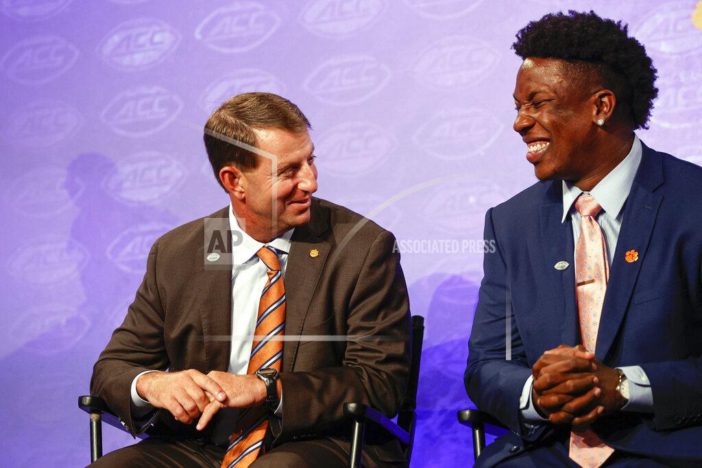 Nell Redmond Clemson head coach Dabo Swinney, left, laughs with defensive end K.J. Henry at the NCAA college football Atlantic Coast Conference Media Days in Charlotte, N.C., Wednesday, July 20, 2022. (AP Photo/Nell Redmond)