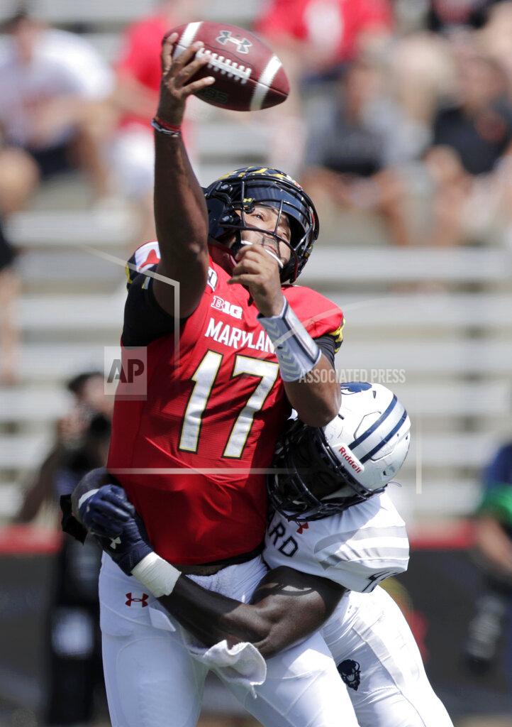 Julio Cortez Maryland quarterback Josh Jackson, left, is hit by Howard defensive lineman Elton Jean-Baptiste while attempting a pass during the first half of an NCAA college football game, Saturday, Aug. 31, 2019, in College Park, Md. (AP Photo/Julio Cortez)