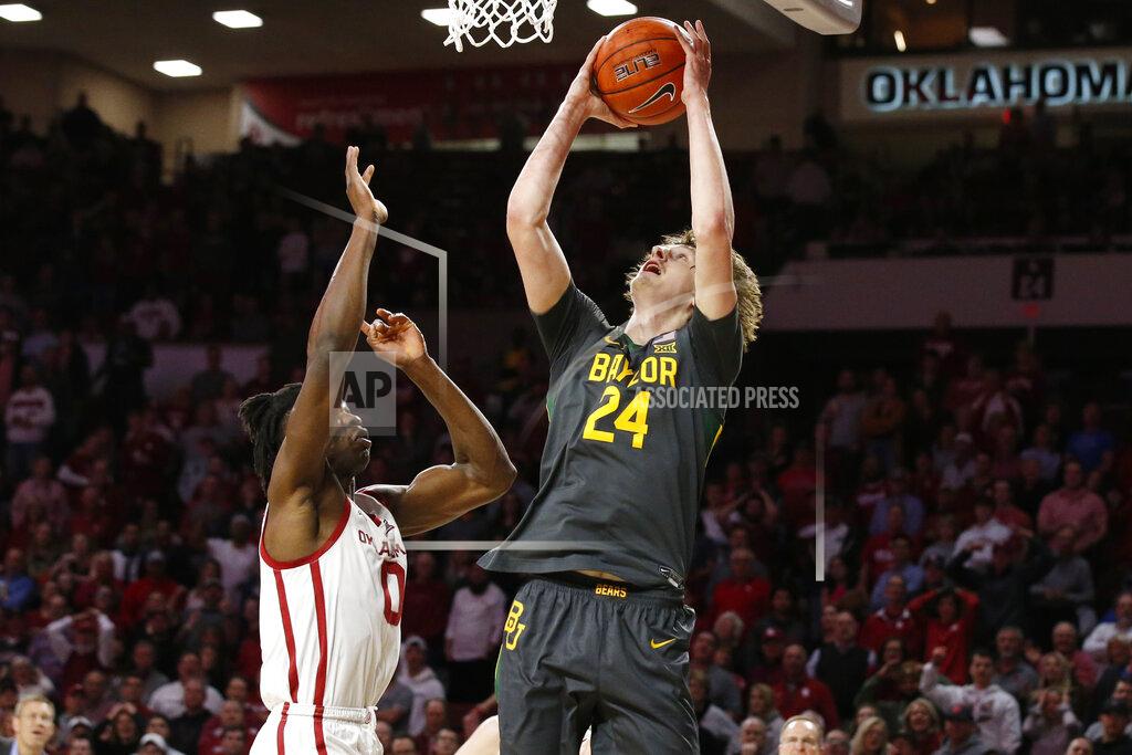 Sue Ogrocki Baylor guard Matthew Mayer (24) shoots in front of Oklahoma forward Victor Iwuakor (0) during the first half of an NCAA college basketball game in Norman, Okla., Tuesday, Feb. 18, 2020. (AP Photo/Sue Ogrocki)