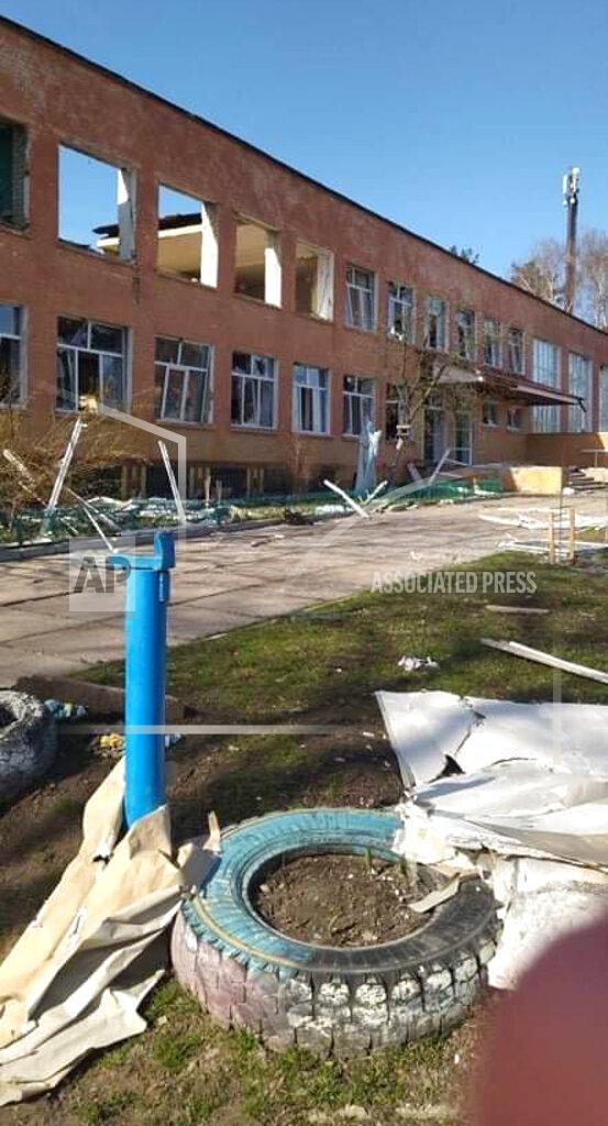 Inna Levchenko This April 24, 2022 photo provided by Inna Levchenko shows damage from Russian shelling to School No. 21, in Chernihiv, Ukraine. Levchenko opened the school as a shelter to hundreds of frightened families. Though she didn’t know it yet, 70 children she’d ordered to shelter in the basement would survive the blast. But at least nine people, including one of her students — a 13-year-old boy — would not. (Inna Levchenko via AP)