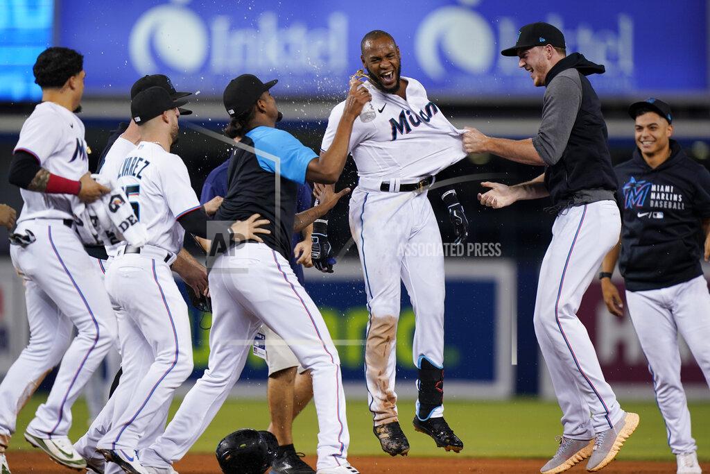Wilfredo Lee Miami Marlins' Bryan De La Cruz, center, is mobbed by teammates after he hit a single scoring Jazz Chisholm Jr. to beat the New York Mets 2-1 in 10 innings of a baseball game, Wednesday, Sept. 8, 2021, in Miami. (AP Photo/Wilfredo Lee)