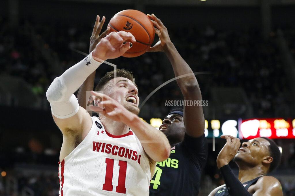 Carlos Osorio Michigan State forward Gabe Brown, center, grabs a rebound next to Wisconsin forward Micah Potter (11) during the first half of an NCAA college basketball game, Friday, Jan. 17, 2020, in East Lansing, Mich. (AP Photo/Carlos Osorio)