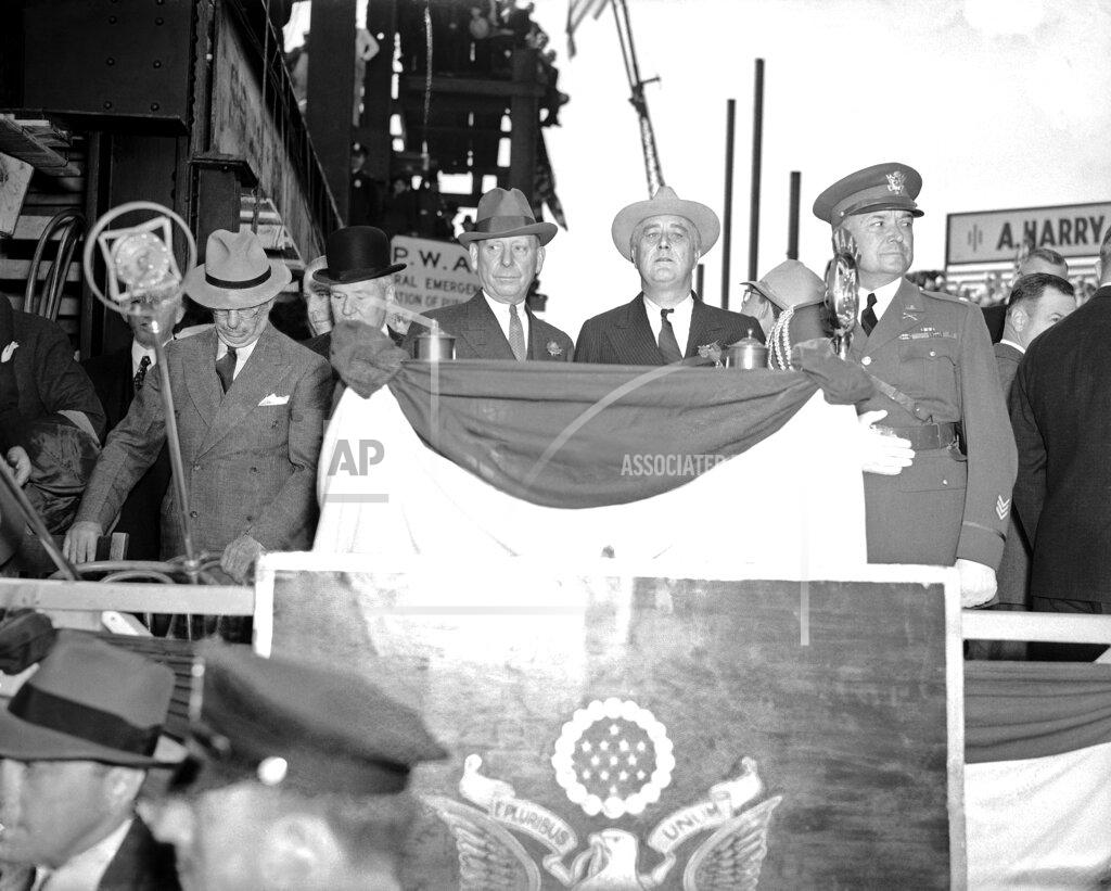 Lhm FILE - In this Oct. 2, 1936, file photo, President Franklin Roosevelt at the new 21-story medical unit which he dedicated in Jersey City, N.J., assuring the medical profession that the New Deal contemplated no action detrimental to it in carrying out the Social Security Act. At left is Mayor Frank Hague of Jersey City and at right is military aide Lt. Col. E.M. Watson. (AP Photo, File)