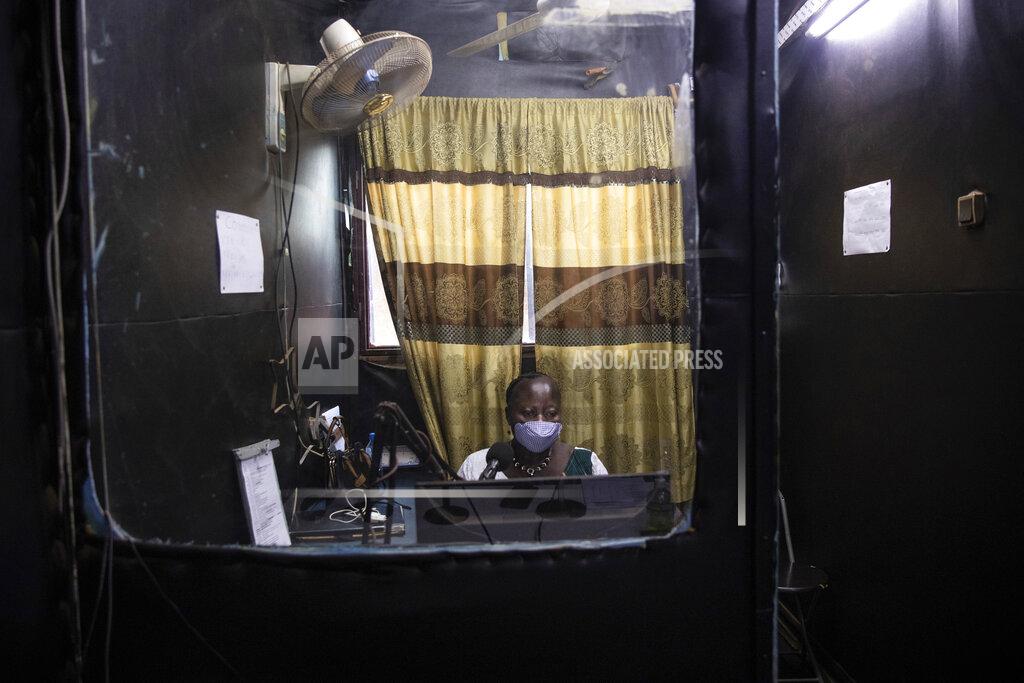 Sophie Garcia Mariama Sawadogo, 44, wears a mask to curb the spread of COVID-19 as she works as a radio host at Zama Radio, in Kaya, Burkina Faso, Monday, Oct. 25, 2021. Many guests and listeners in Burkina Faso call her "aunty" as she gently guides them to the right answers and awards prizes such as soap and washing buckets. In the West African country of Burkina Faso, many feel the government has let them down during the pandemic. Tests, vaccines and messaging often miss many residents, despite a $200 million budget for virus-response efforts. In a region where women are responsible for family work and community relationships, they’ve stepped up to fill in gaps. (AP Photo/Sophie Garcia)
