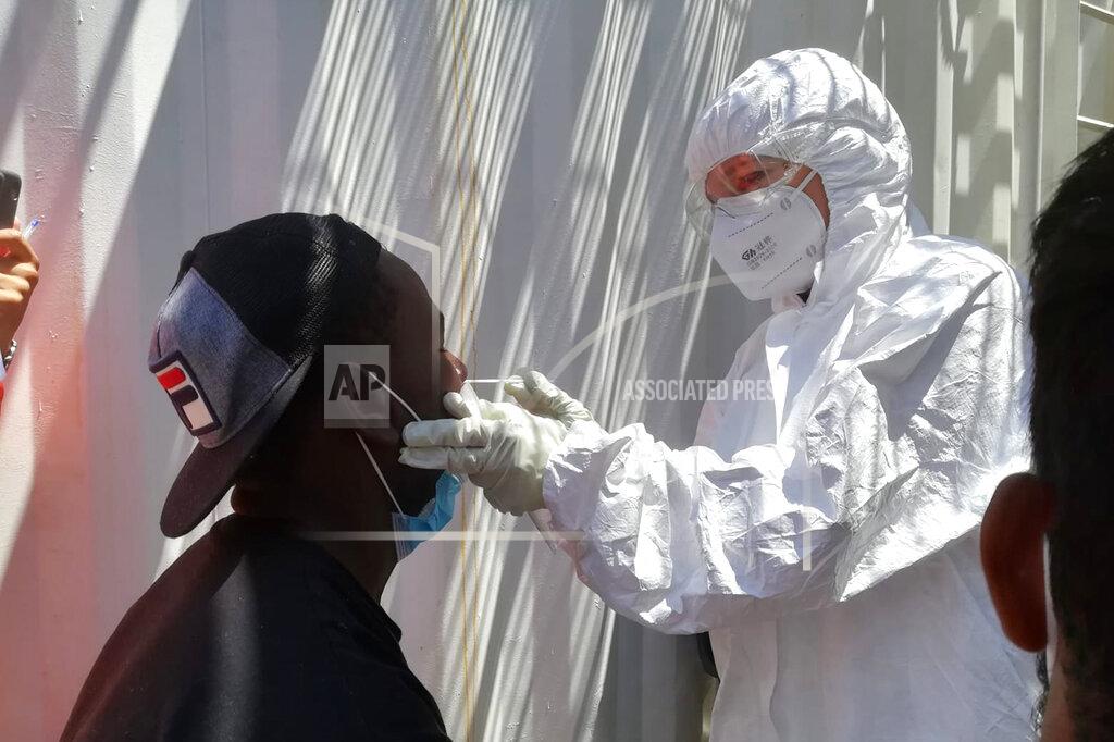 Laurence Bondard A medical staffer conducts COVID-19 tests aboard the Ocean Viking ship in the Mediterranean Sea, Sunday, July 5, 2020. A humanitarian group says its rescue ship with 180 migrants stranded aboard for days has “finally” received instructions to sail to an Italian port, so its passengers can be disembarked. SOS Mediterranee in a tweet on Sunday also described “relief on the #Ocean Viking” when the ship's crew and passengers learned that the rescued migrants are to be disembarked at Porto Empedocle, Sicily, the next day. (Laurence Bondard/SOS Mediterranee via AP)