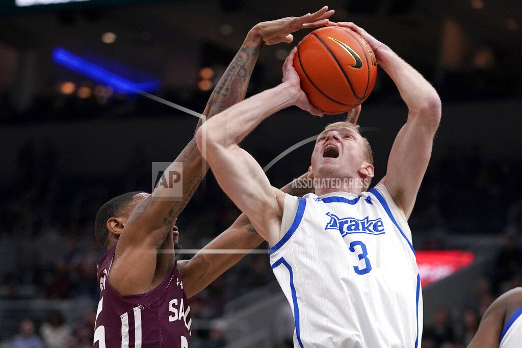 Jeff Roberson Drake's Garrett Sturtz (3) is fouled on his way to the basket by Southern Illinois' Ben Coupet Jr. during the first half of an NCAA college basketball game in the quarterfinal round of the Missouri Valley Conference tournament Friday, March 4, 2022, in St. Louis. (AP Photo/Jeff Roberson)