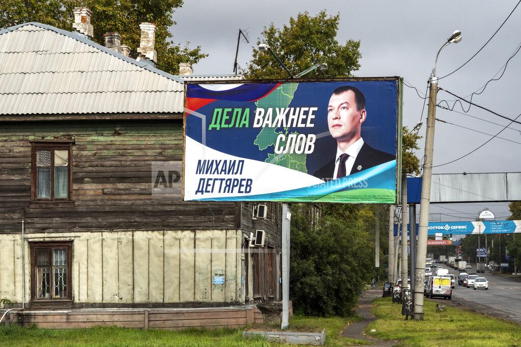 Igor Volkov An election poster with a portrait of Mikhail Degtyaryov, a member of the nationalist Liberal Democratic Party and saying "Actions are more important than words," is displayed in the Russian city of Khabarovsk in the country's Far East, Thursday, Sept. 9, 2021. Degtyaryov is on the ballot for governor in the three days of regional voting that concludes Sunday, Sept. 19, 2021. (AP Photo/Igor Volkov)