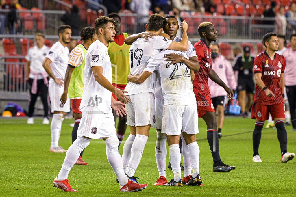 Christopher Katsarov Inter Miami forward Federico Higuain (22), forward Robbie Robinson (19) and defender Christian Makoun celebrate after the team's win over Toronto FC in an MLS soccer match Tuesday, Sept. 14, 2021, in Toronto. (Christopher Katsarov/The Canadian Press via AP)