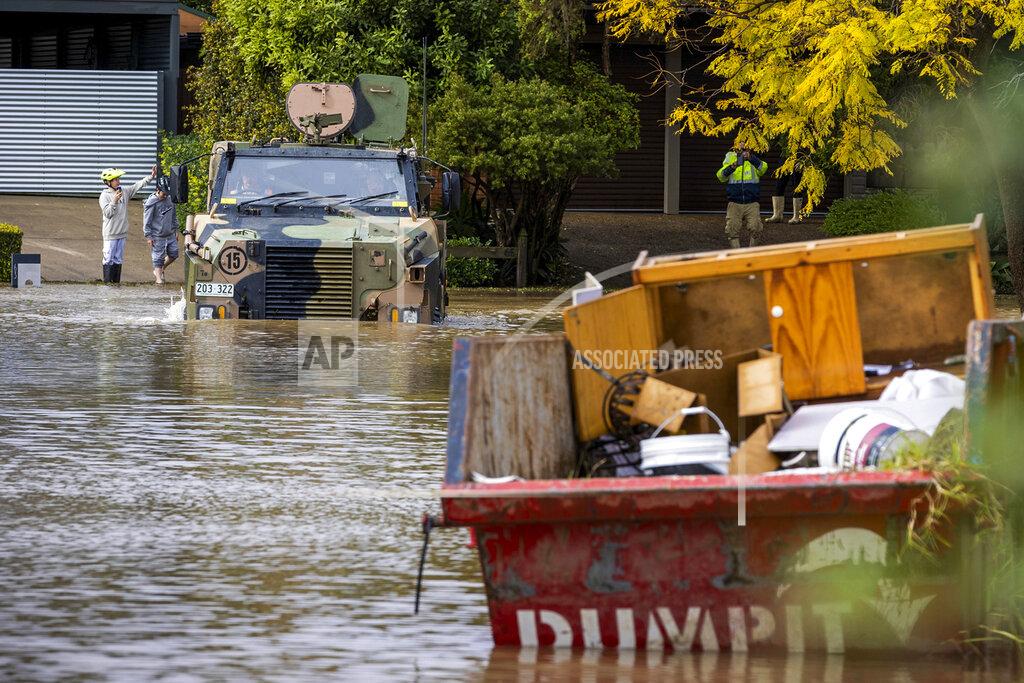 Cpl David Cotton An Australian Army Bushmaster Protected Mobility Vehicle drives through a flooded street in McGrath Hills on the outskirts of Sydney, Monday, July 4, 2022. More than 50,000 residents of Sydney and its surrounds have been told to evacuate or prepare to abandon their homes on Tuesday as Australia's largest city braces for what could be its worst flooding in 18 months. (CPL David Cotton/Australian Defense Dept. via AP)