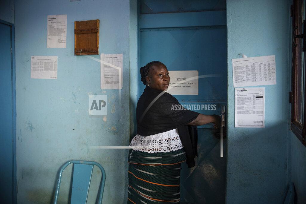 Sophie Garcia Mariama Sawadogo, 44, arrives at her works as a radio host at Zama Radio, in Kaya, Burkina Faso, Monday, Oct. 25, 2021. Many guests and listeners in Burkina Faso call her "aunty" as she gently guides them to the right answers and awards prizes such as soap and washing buckets. In the West African country of Burkina Faso, many feel the government has let them down during the pandemic. Tests, vaccines and messaging often miss many residents, despite a $200 million budget for virus-response efforts. In a region where women are responsible for family work and community relationships, they’ve stepped up to fill in gaps. (AP Photo/Sophie Garcia)