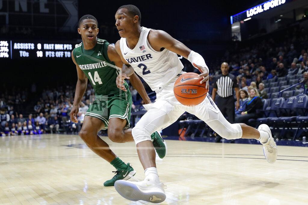 John Minchillo Xavier's Dahmir Bishop (2) drives against Jacksonville's Mo Arnold (14) during the second half of an NCAA college basketball game Tuesday, Nov. 5, 2019, in Cincinnati. (AP Photo/John Minchillo)