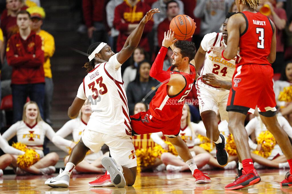 Charlie Neibergall Texas Tech guard Davide Moretti passes around Iowa State forward Solomon Young (33) during the first half of an NCAA college basketball game Saturday, Feb. 22, 2020, in Ames, Iowa. (AP Photo/Charlie Neibergall)